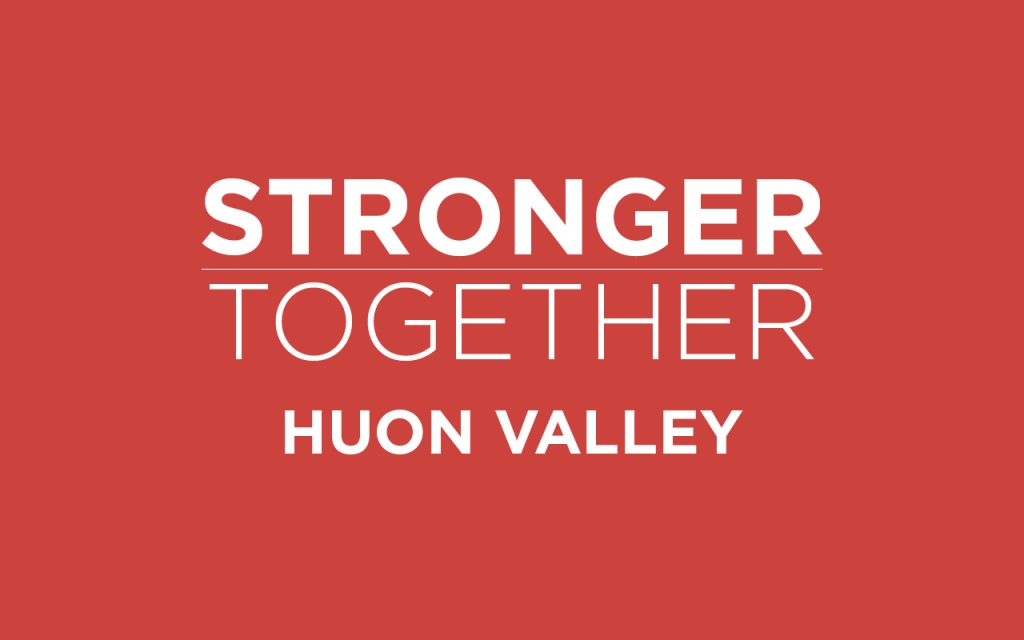 Red background with white text in bold capital letters: STRONGER TOGETHER HUON VALLEY.