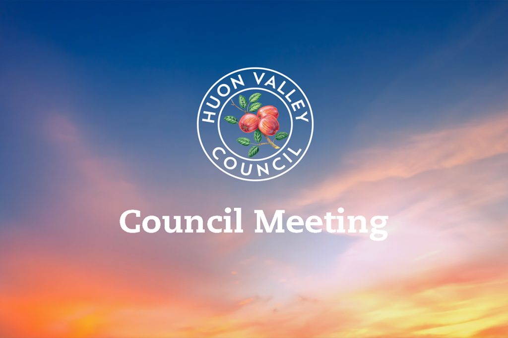 Logo of Huon Valley Council with apples and leaves inside a circle on a backdrop of a colorful sunset sky. Text reads Council Meeting.