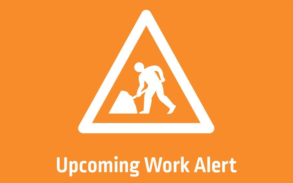 Orange triangular sign with a white silhouette of a person digging, indicating construction work. Below the triangle, the text reads Upcoming Work Alert.