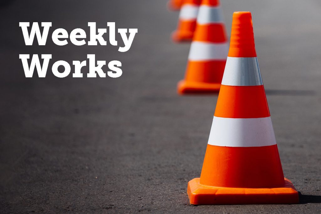 Orange traffic cones lined up on a road with the text Weekly Works on the left side. The image suggests ongoing or upcoming construction or maintenance work.