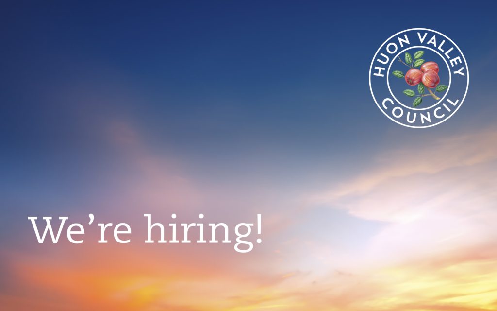 A sunset sky with hues of orange and blue is in the background. Text on the left reads Were hiring! The top right displays a round logo with Huon Valley Council, featuring apples and leaves.