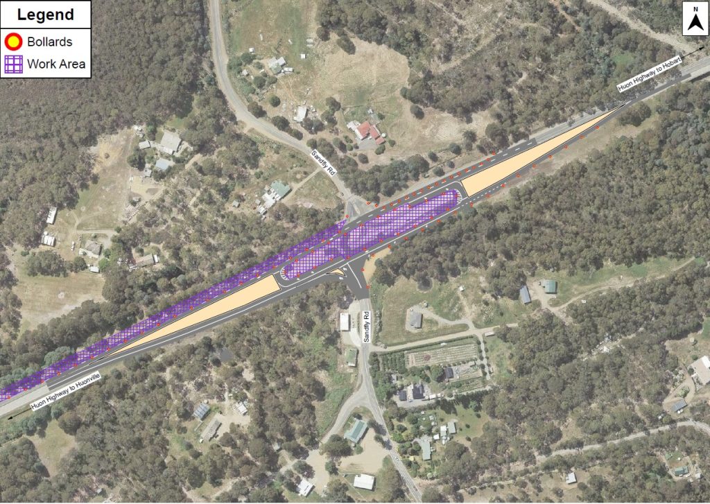 Aerial view of a rural road with marked work area in purple and bollards in red on either side of the road. Surrounding landscape includes trees, fields, and a few buildings. A legend indicates symbols for bollards and the work area.