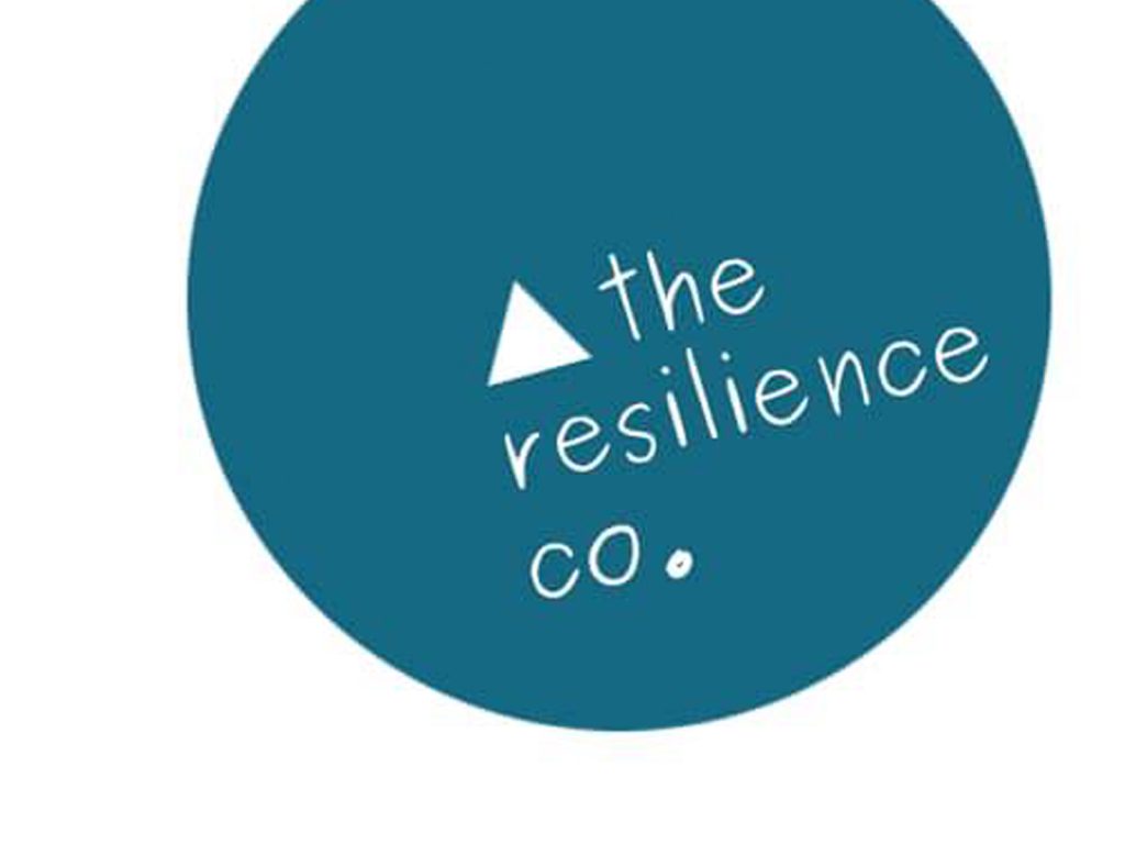 Blue circular logo with the text the resilience co. in lowercase letters, featuring a small white triangle above the text.