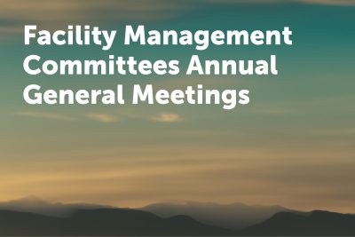 Text reads Facility Management Committees Annual General Meetings over a scenic background of mountains and a sunset sky.