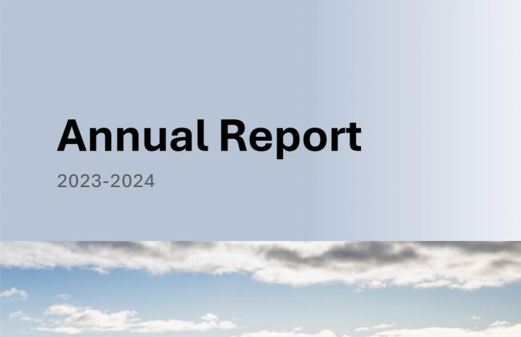 Cover page of a document titled Annual Report 2023-2024 with a gradient background. Below the title, there is an image of a partly cloudy sky with blue tones.