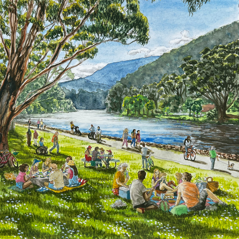 A lively riverside scene with people having picnics, bicycling, and walking. The grassy area is shaded by large trees, with mountains and a flowing river in the background. The atmosphere is vibrant and sociable.