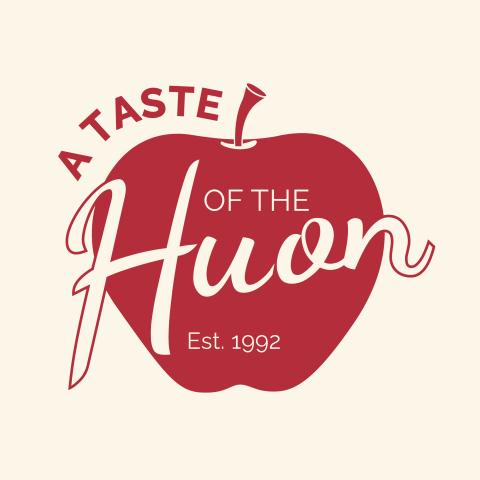Red apple graphic with the words A Taste of the Huon and Est. 1992 in white and red text, featuring a script font for Huon.