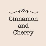 Beige background with decorative lines and a small heart above the text Cinnamon and Cherry written in a bold, serif font.