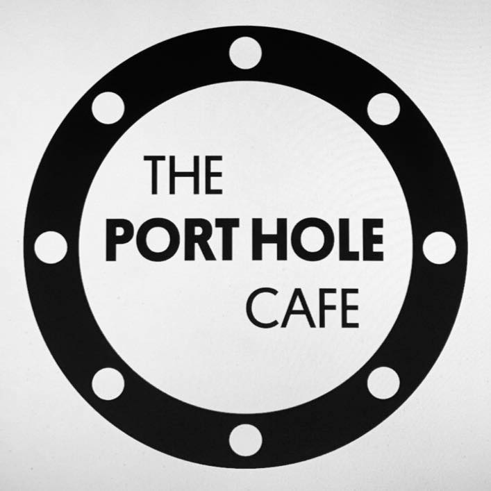 Black and white logo for The Port Hole Cafe, featuring the text inside a circular ship porthole design with bolt details around the edge.