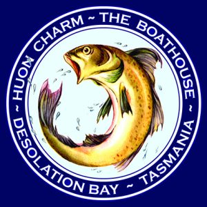 Circular logo with a leaping fish in the center. Around the fish, white text on a blue border reads: HUON CHARM ~ THE BOATHOUSE ~ DESOLATION BAY ~ TASMANIA.