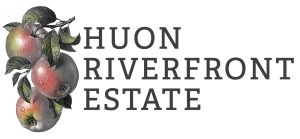 Three apples with leaves are illustrated on the left, beside the bold text HUON RIVERFRONT ESTATE on a white background.