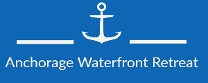 White anchor icon above the text Anchorage Waterfront Retreat on a blue background, flanked by horizontal white lines on both sides.