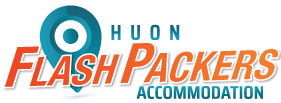 Logo for Huon Flash Packers Accommodation featuring a blue location pin graphic and bold orange text for Flash Packers. Huon and Accommodation are written in blue.