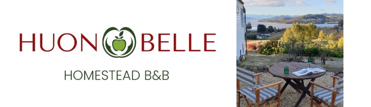 Logo for Huon Belle Homestead B&B with a green apple icon, plus a photo of an outdoor table and chairs overlooking a scenic landscape with hills, water, and trees.