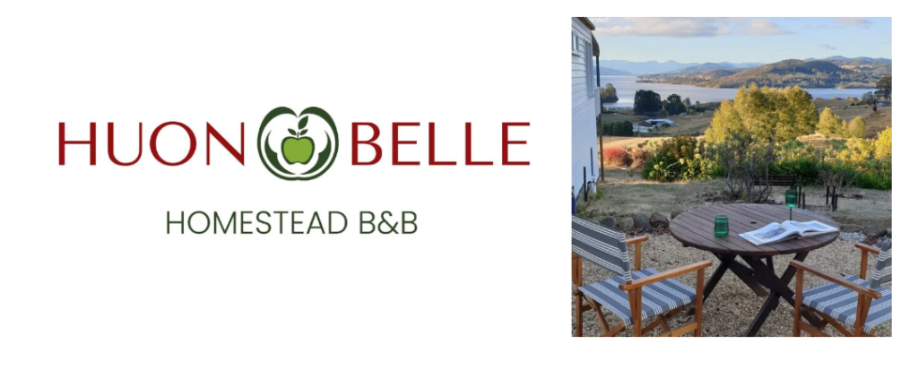 HUON BELLE Homestead B&B logo with a green apple, next to a photo of an outdoor table and chairs overlooking a scenic landscape with hills, water, and trees.