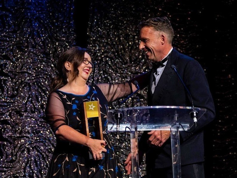 A man and woman standing at a podium.