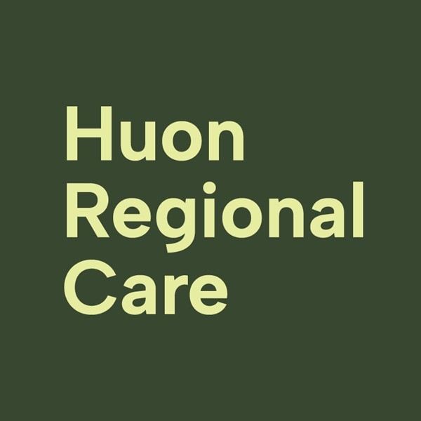 Light yellow text on a dark green background reads Huon Regional Care in a bold, sans-serif font, arranged over three lines.