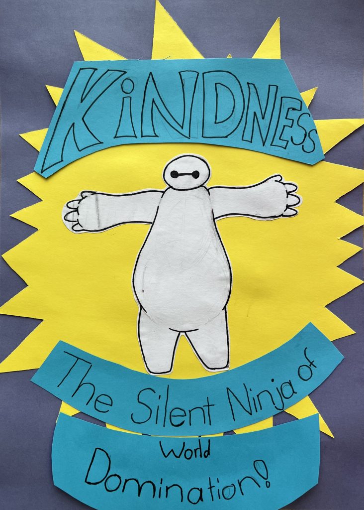 A paper collage of Baymax from Big Hero 6 with the words KINDNESS above him and The Silent Ninja of World Domination! below, all set against a yellow starburst on a gray background.