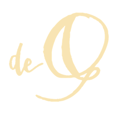 Light yellow handwritten text on a pale background reads de Q with a large, stylized letter Q and small, cursive de to its left.